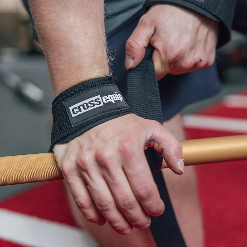 cross equip Padded Straps am Handgelenk beim Griff an goldener Langhantelstange